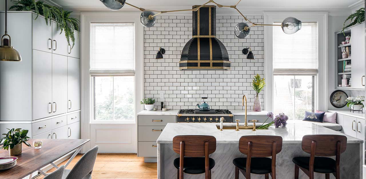 Custom black powdercoated range hood against white subway tiles