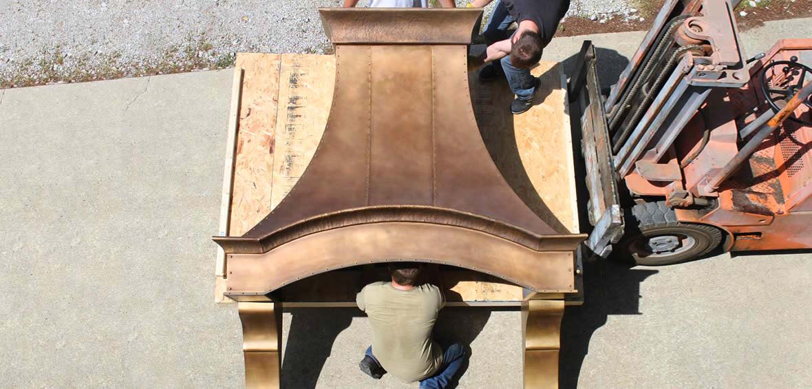 Photo of custom bronze range hood being loaded onto a palette.